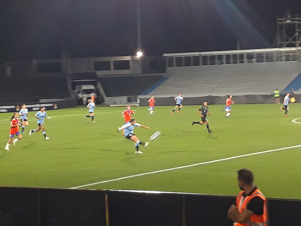 Hinchas revisando noticias deportivas desde sus celulares en la calle